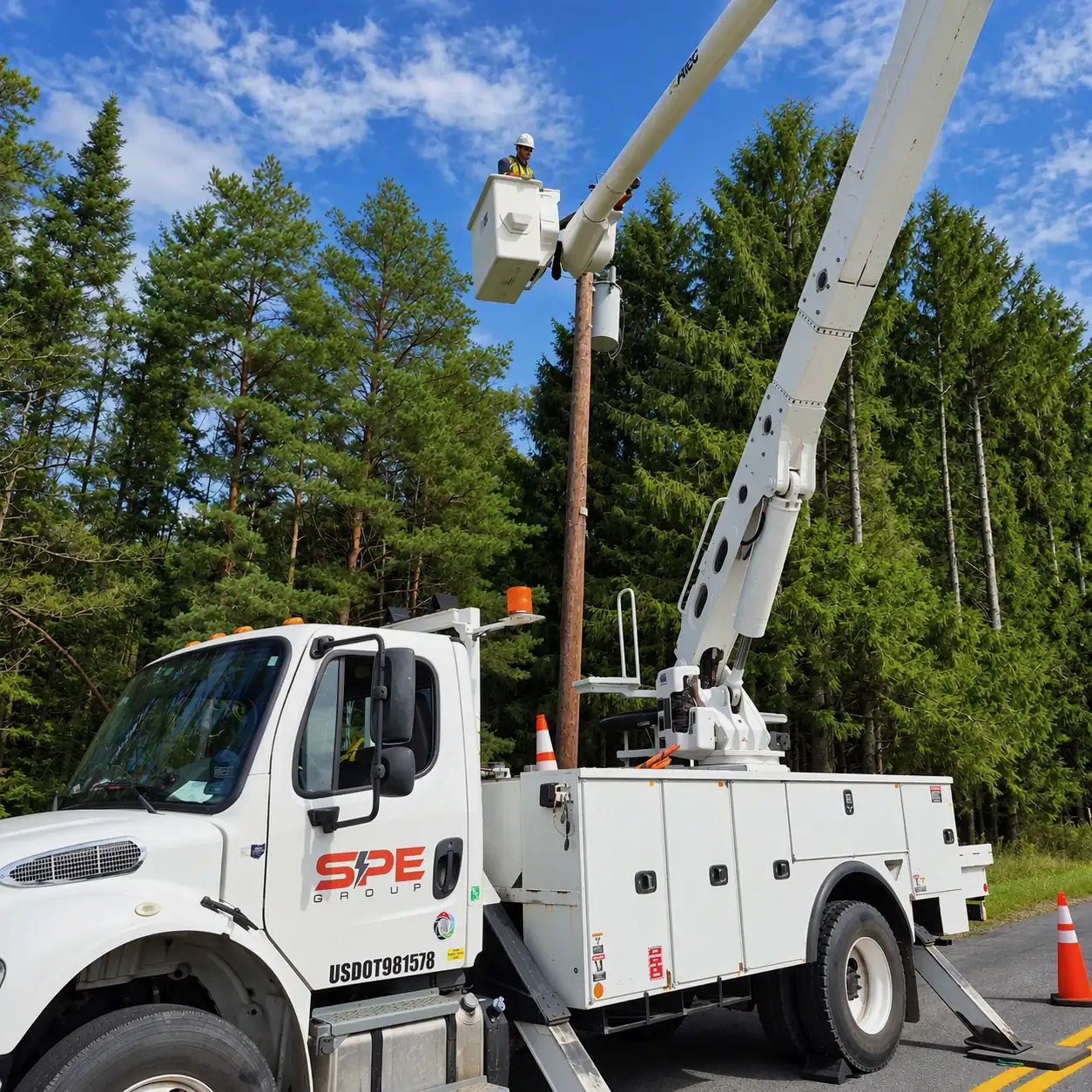 SPE bucket truck crew working an overhead distribution line