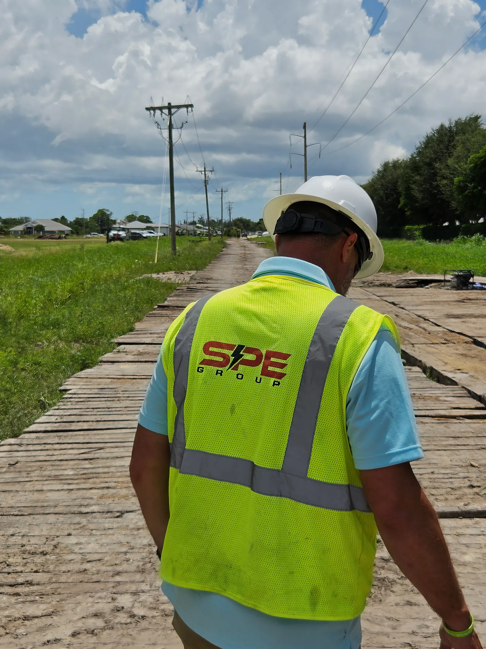 SPE supervisor walking a matted access road on site