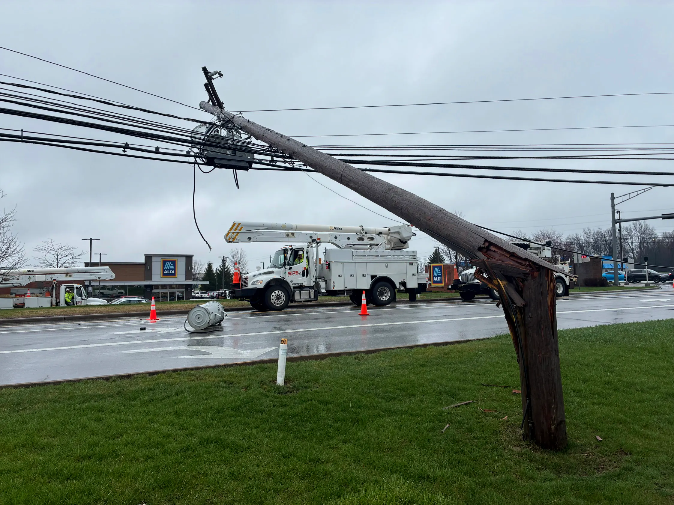 Storm-snapped utility pole with an SPE bucket truck responding